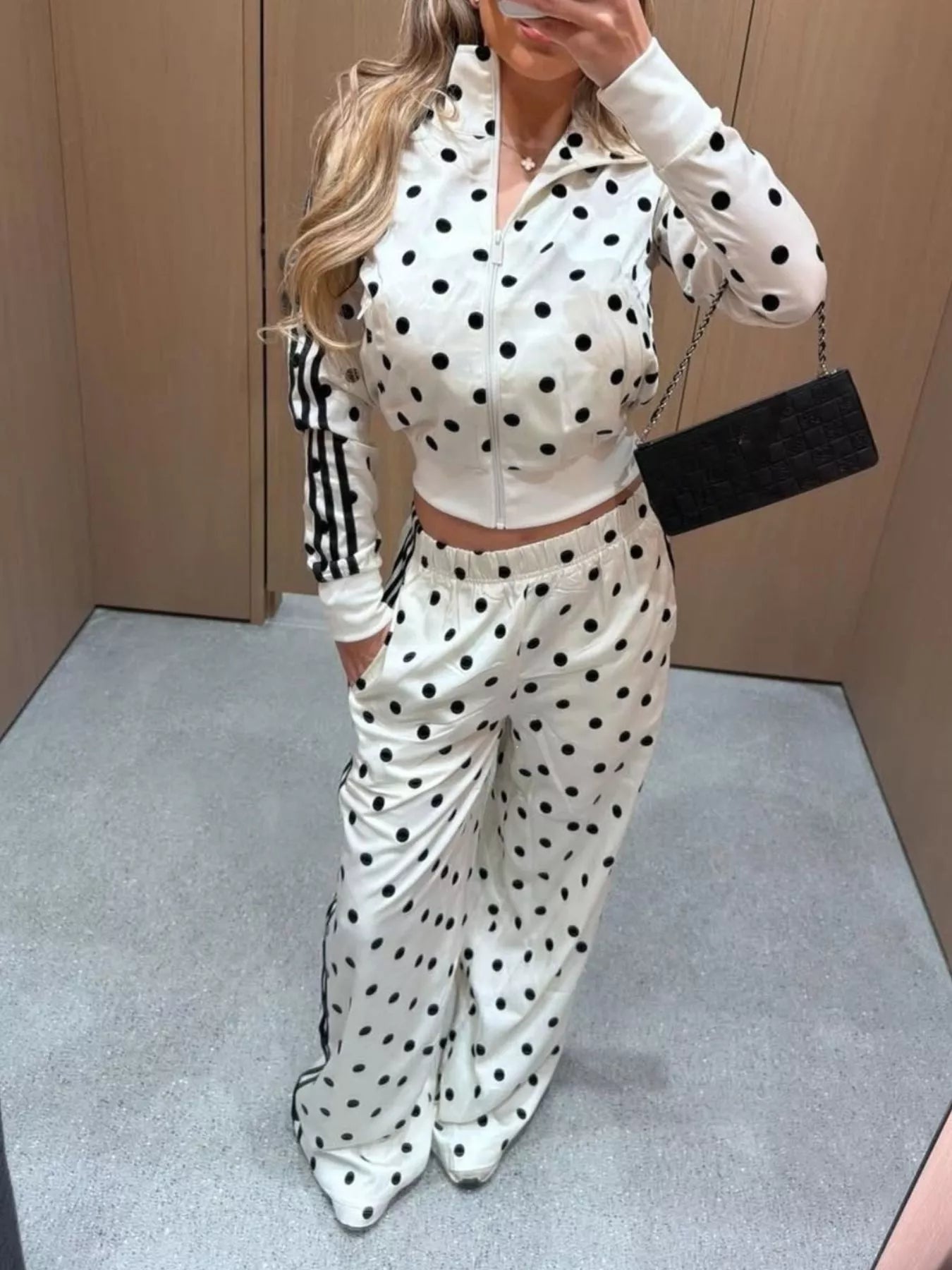 White polka-dot zip-up jacket and matching wide-leg pants set, sporty stripe details