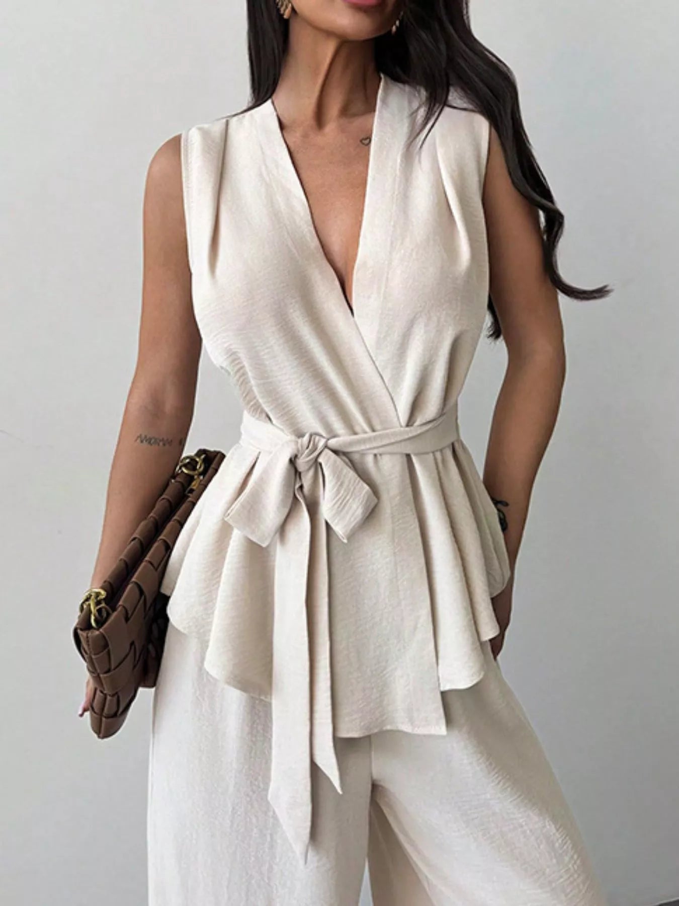 White sleeveless wrap top and wide-leg pants set with tie-front waist and V-neck