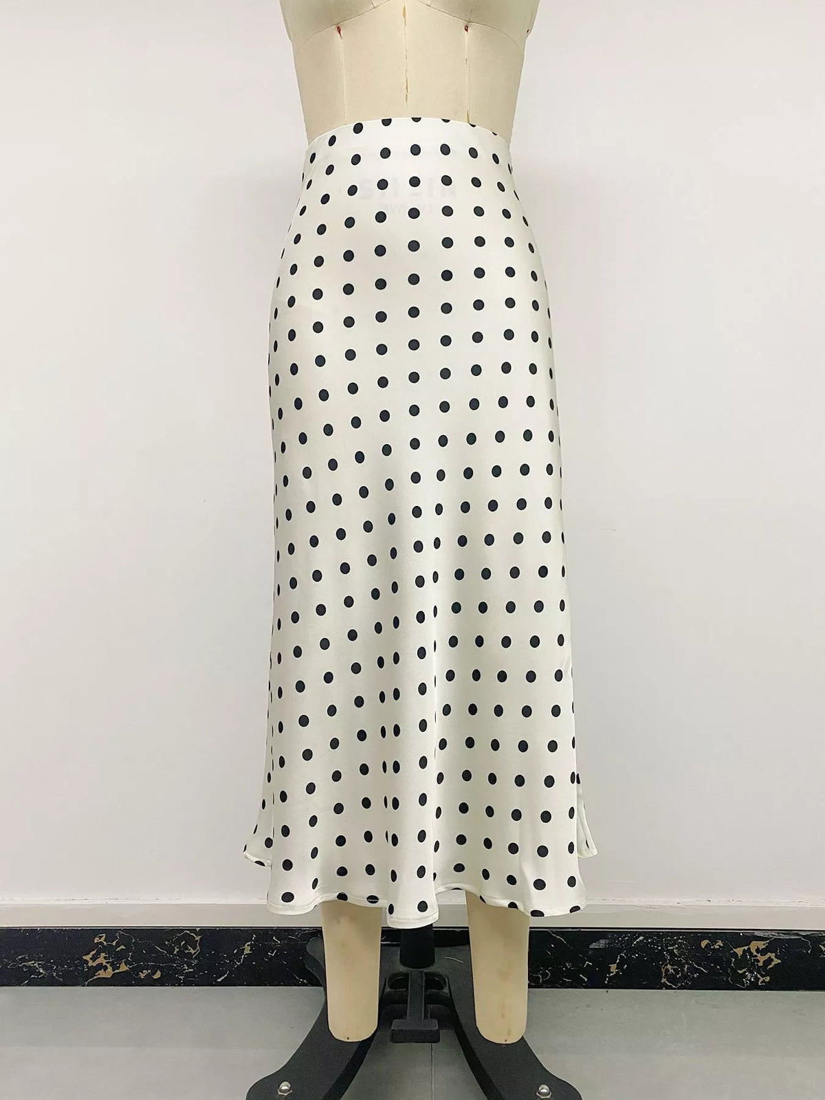 Cream polka dot midi skirt with black dots, shown on mannequin, full A-line length