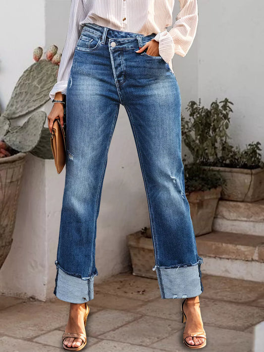 Medium wash straight jeans with stepped waist and raw hem cuffs