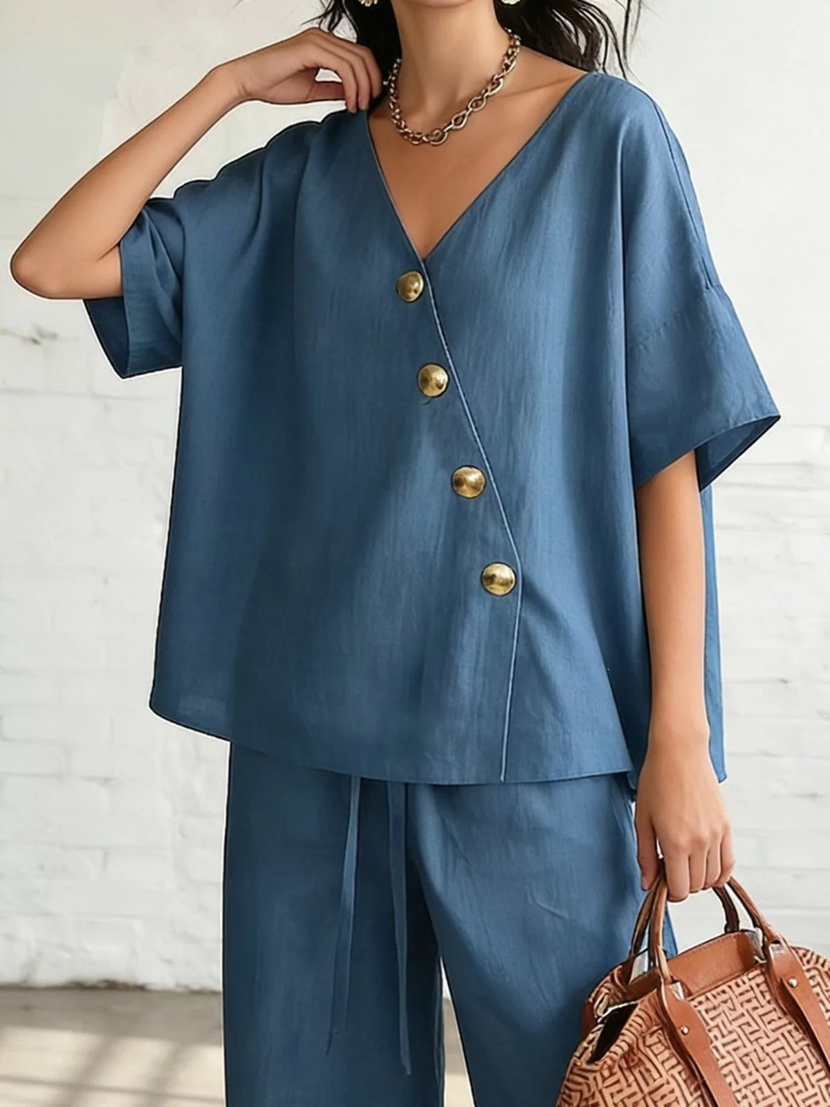 Blue surplice half-sleeve top with gold buttons and flowing wide-leg pants