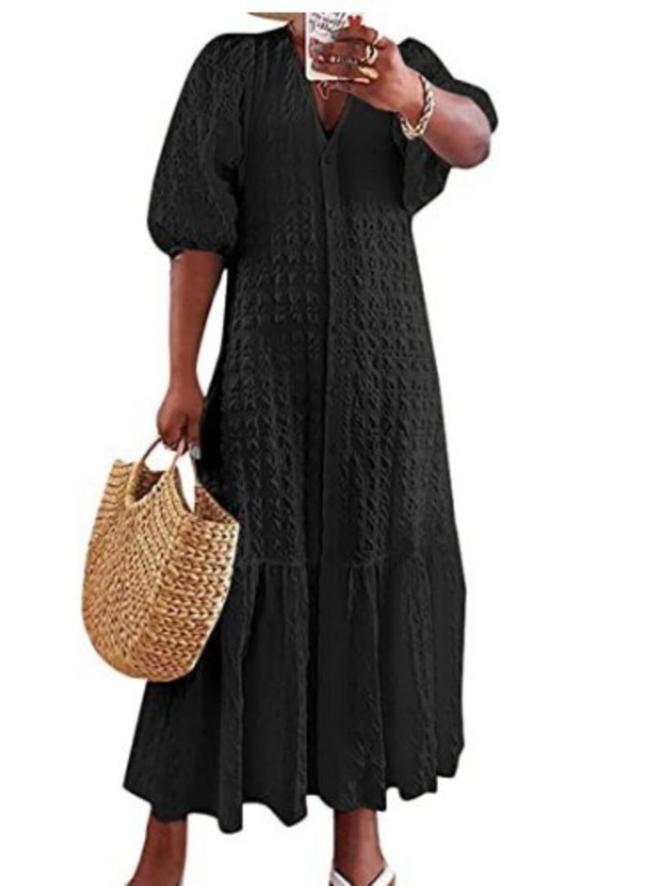 Black textured maxi dress with V-neck, puff sleeves, and tiered skirt with ruffle detail
