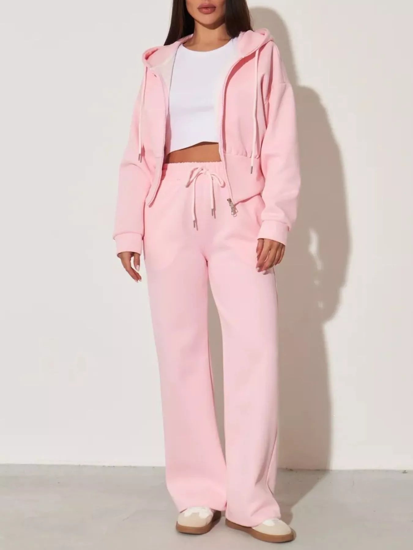 Pink zip-up hoodie and wide-leg pants set, front view with drawstring and wide-leg silhouette