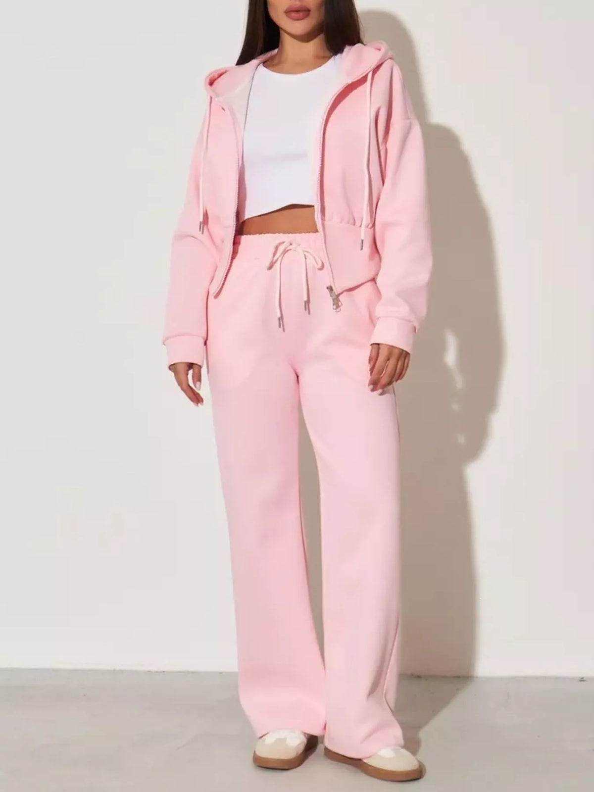 Pink zip-up hoodie and wide-leg pants set, front view with drawstring and wide-leg silhouette