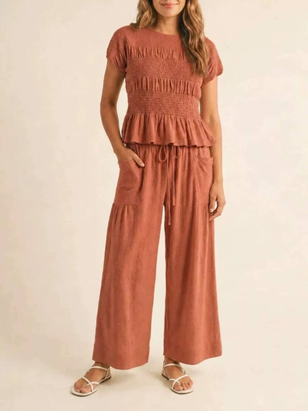 Terracotta smocked peplum top and wide-leg pants set with tiered ruffle peplum and drawstring waist