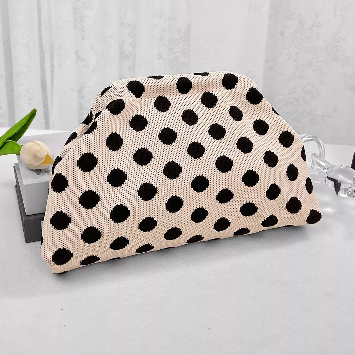Cream knit polka-dot clutch with black dots