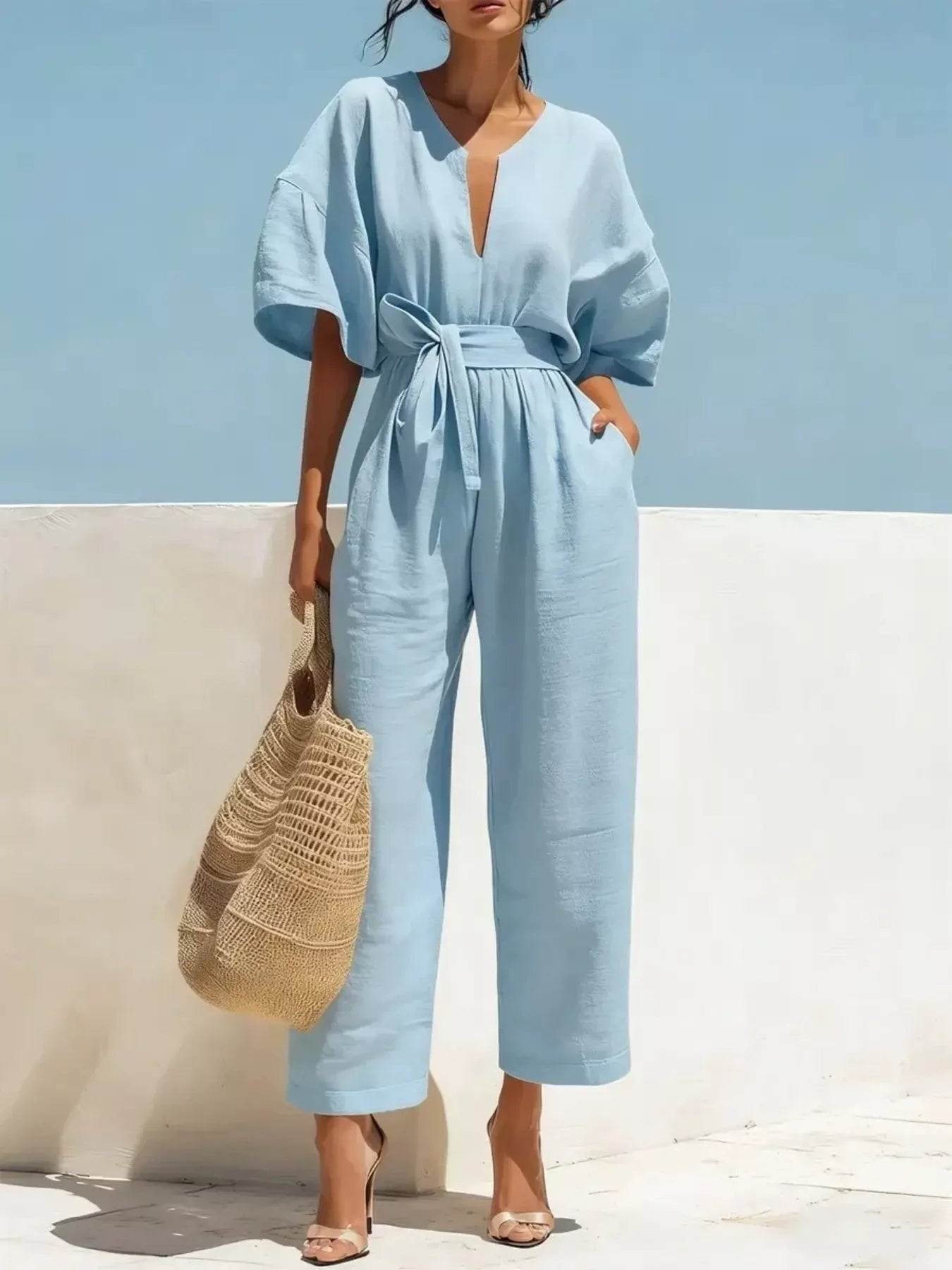 Sky blue tie-waist wide-leg jumpsuit with V-neck and short puff sleeves