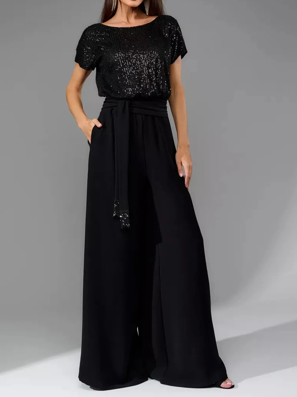 Black sequin short-sleeve wide-leg jumpsuit with tied waist and draped pants