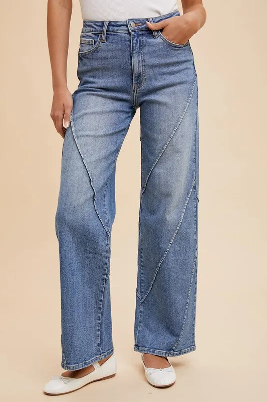 Medium-wash wide-leg jeans with decorative seam detailing on legs and pockets