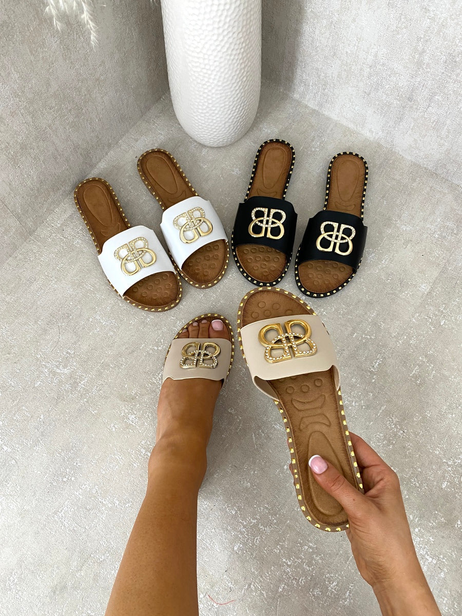 Assorted flat sandals with gold BB buckle emblem and studded edges, open-toe slide