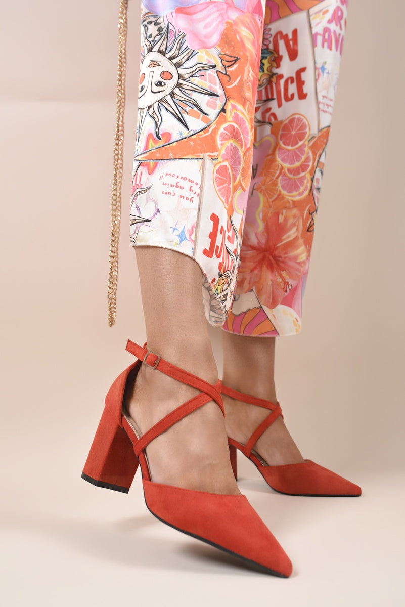 Red cross-strap block heels with pointed toe and ankle strap detail