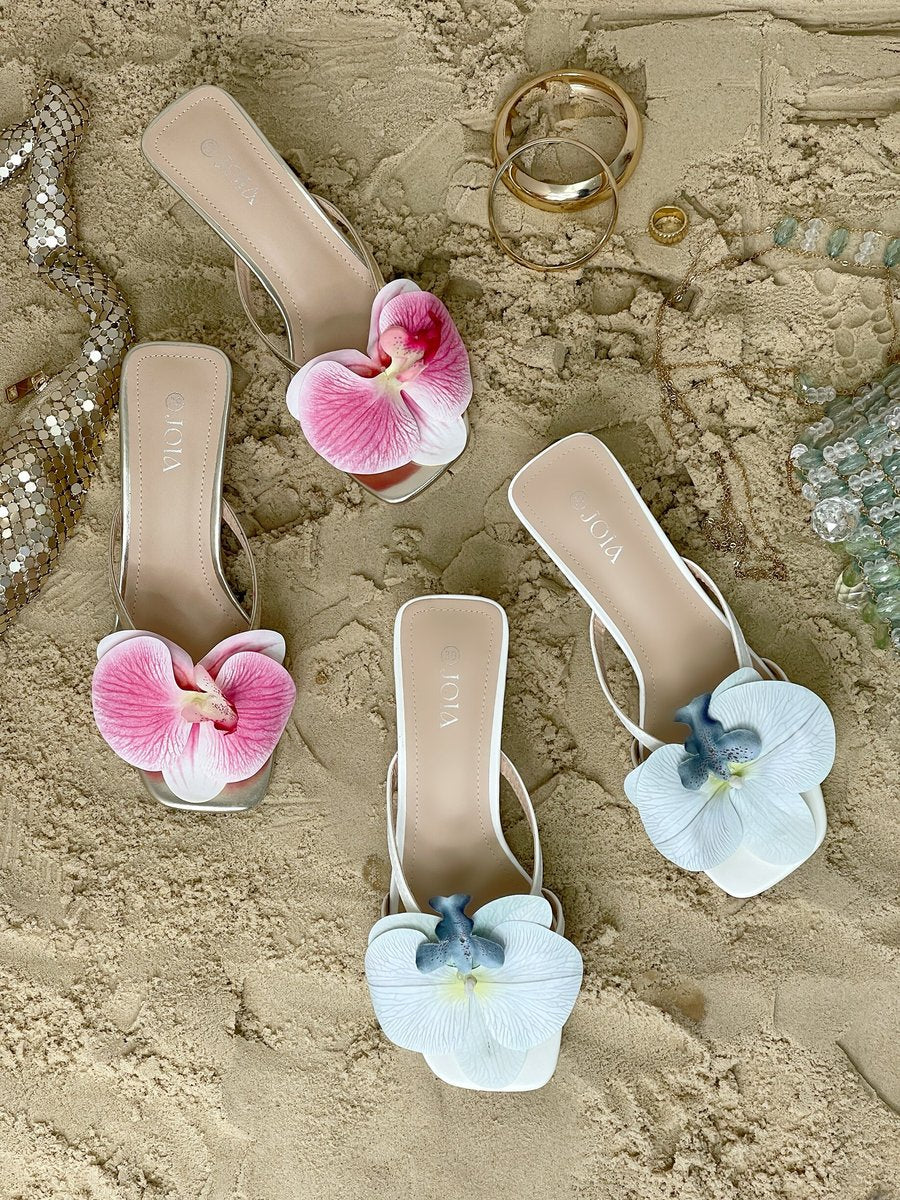 White floral slide mules with blue and pink orchid flowers, low block heels