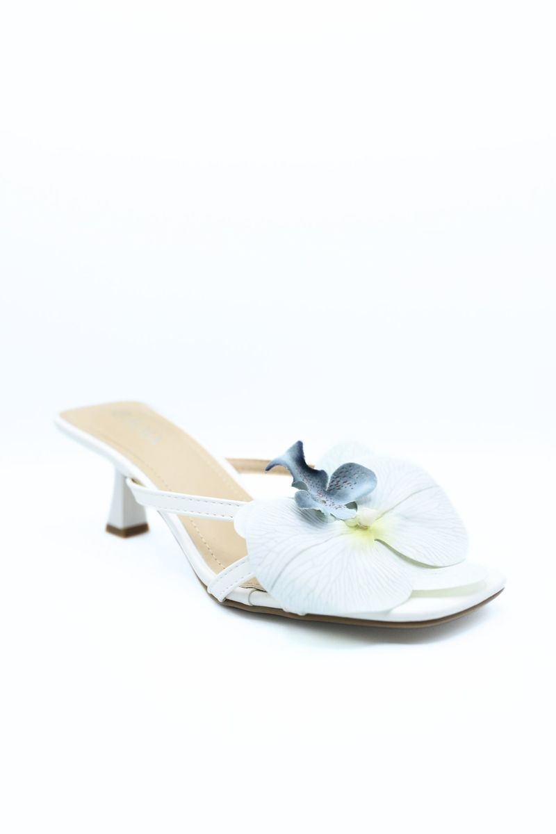 Cream slide mule sandal with blue orchid flower accent and low heel