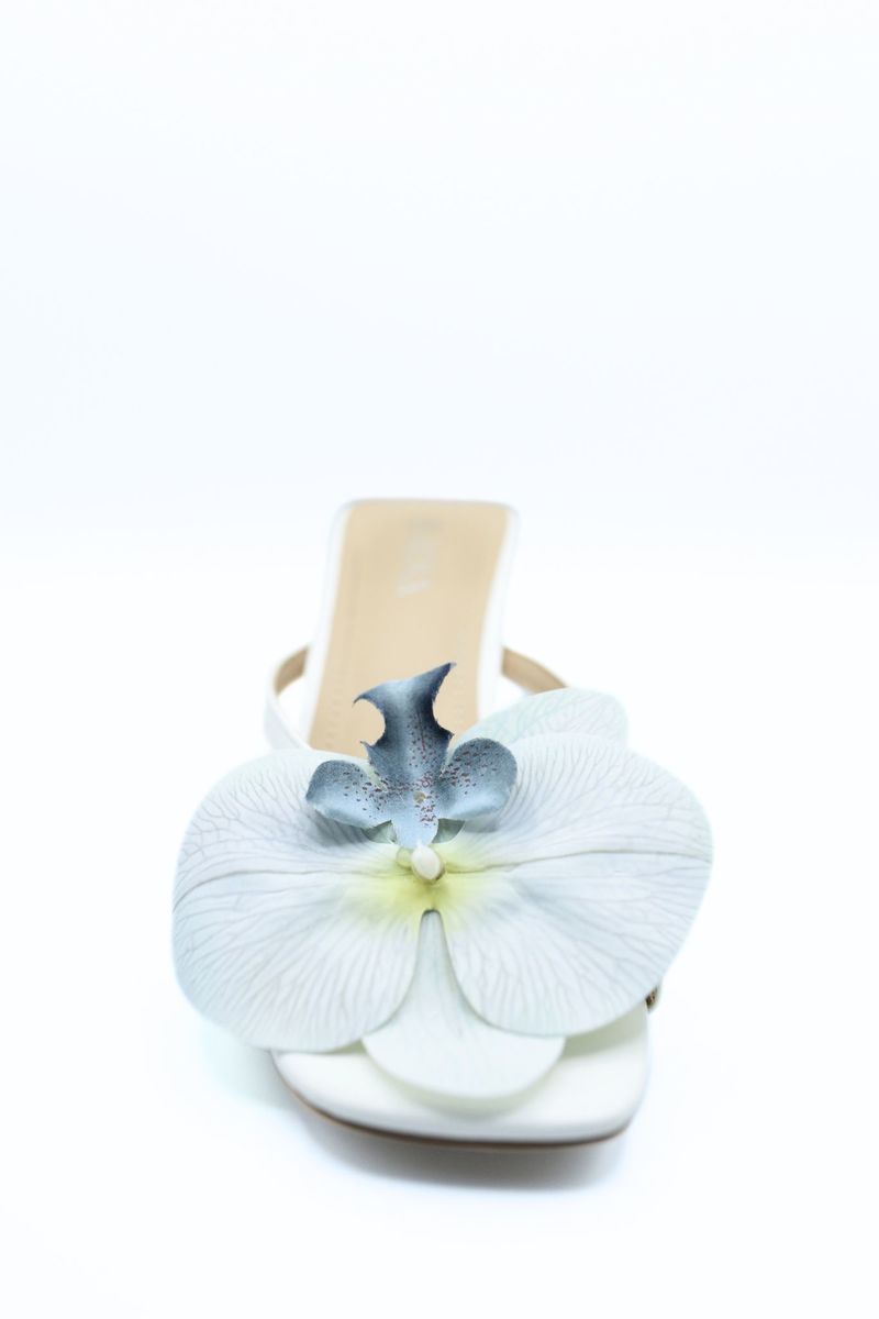 Cream slide mule with oversized blue orchid flower and low block heel