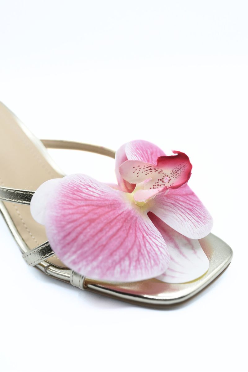 Metallic floral high heel mule with oversized pink orchid flower on the front strap.