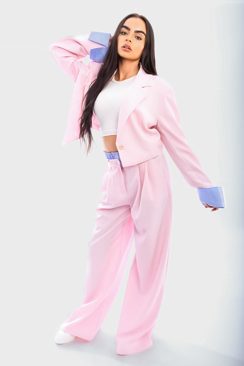 Pink blazer crop jacket with straight-leg trousers and blue-striped cuffs