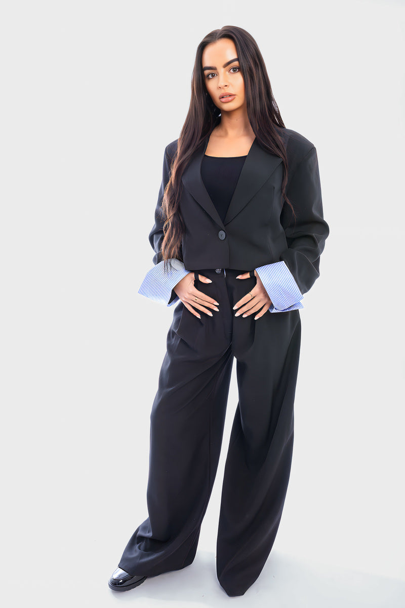Black cropped blazer and straight-leg trousers with light blue striped cuffs