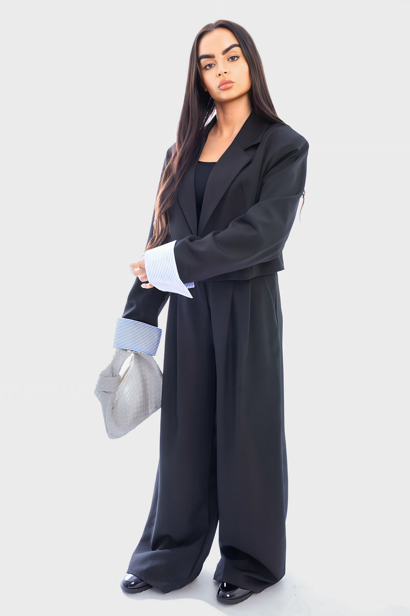 Black cropped blazer and straight-leg trousers with light blue striped cuffs