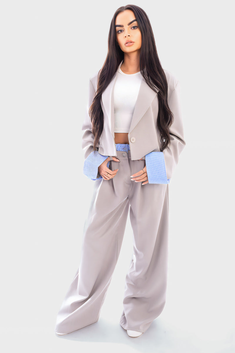 Light gray cropped blazer and straight-leg trousers with blue striped cuffs
