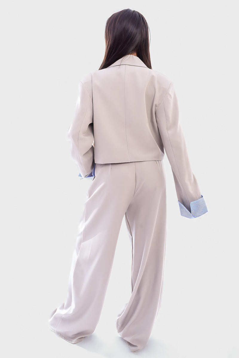 Light gray cropped blazer and straight-leg trousers, back view, blue striped cuffs