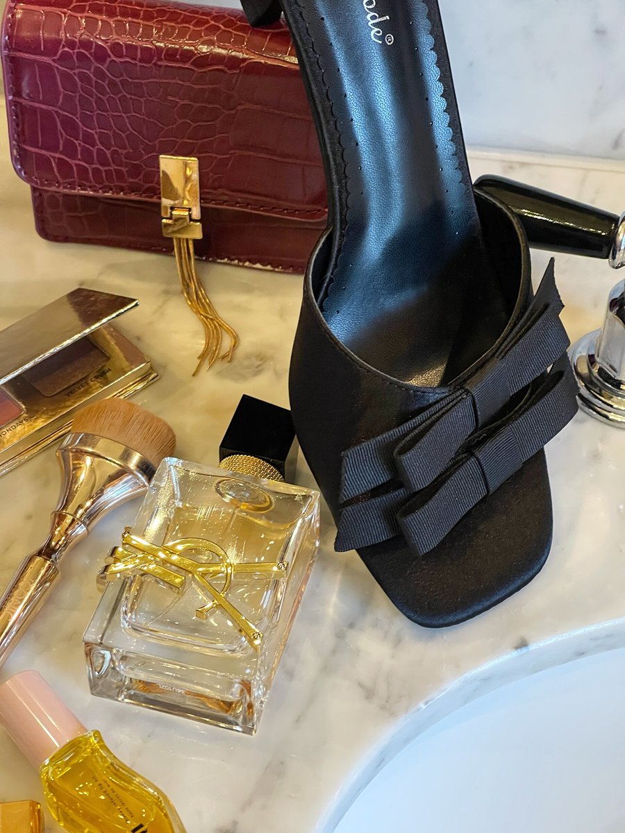 Black open-toe high heel with bow strap detail and stiletto heel, side view