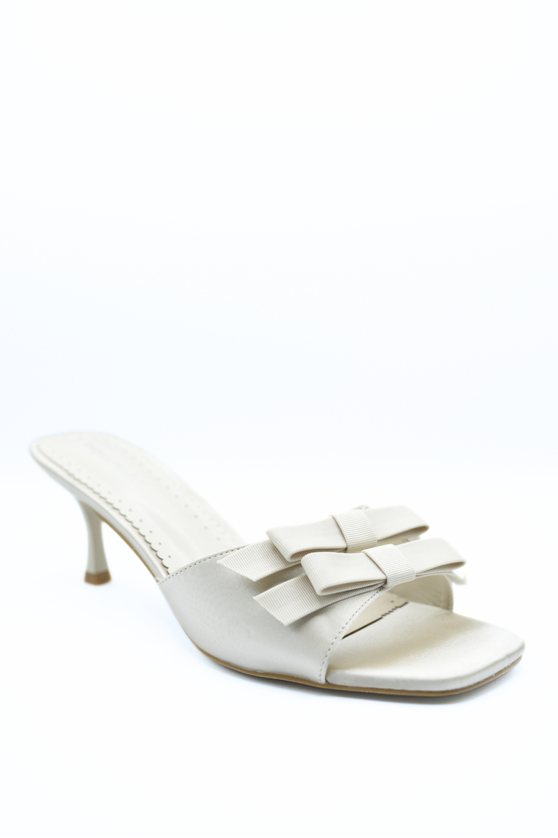 Cream open-toe high heel mule with layered bow straps and stiletto heel