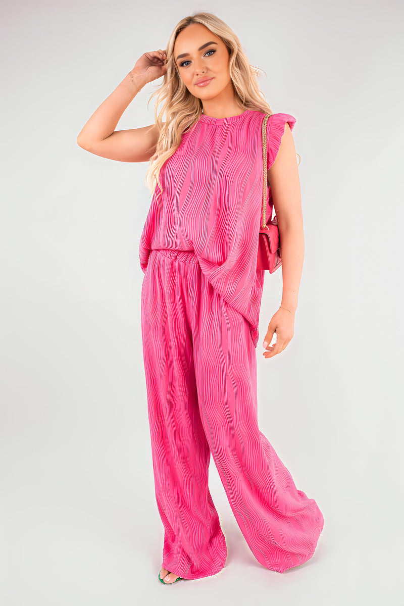 Fuschia textured sleeveless top with frill shoulders and wide-leg trousers