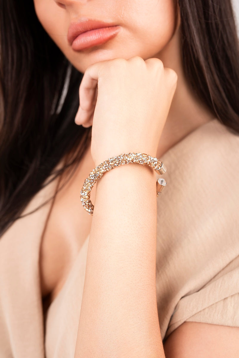 Crystal twist open-cuff bracelet with gold-tone stones and small clear charm