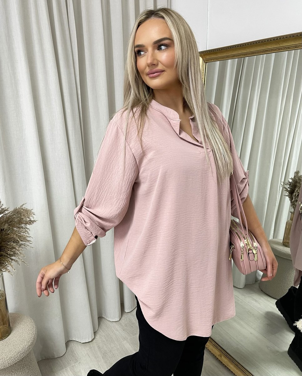Loose-fit tunic top in pink with long sleeves and side slits