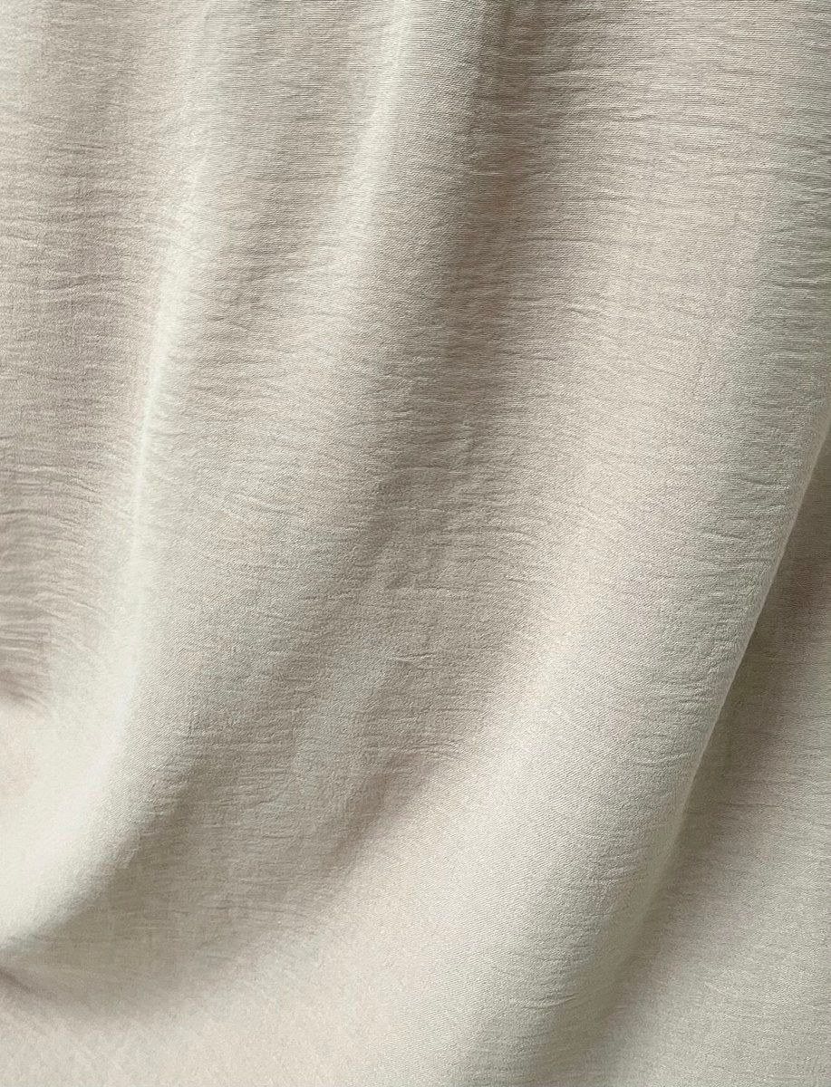 Light-colored fabric close-up with subtle texture