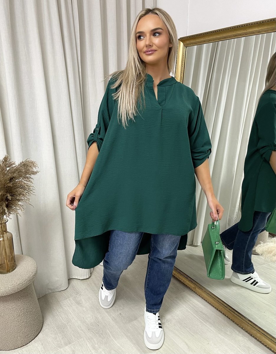 Loose-fit long-sleeve top in dark green with roll-up sleeves and asymmetric hem