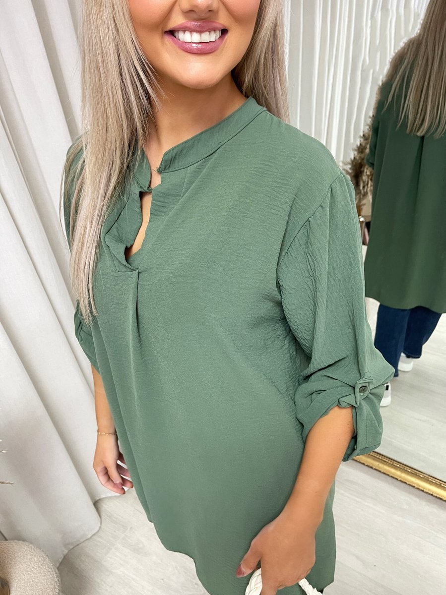 Loose-fit tunic top in dark green with front button placket and gathered sleeves