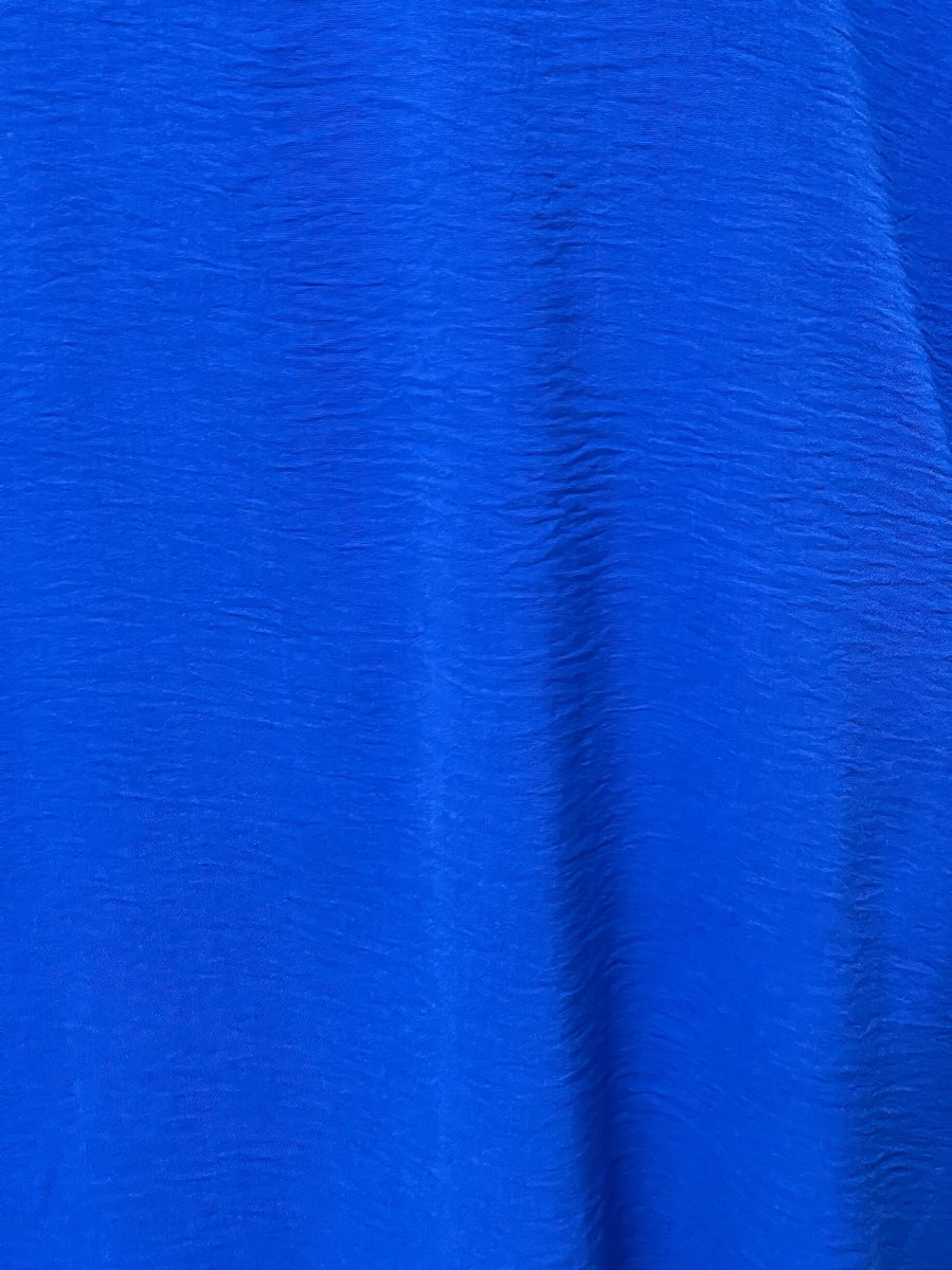Royal blue fabric texture close-up with subtle wrinkles