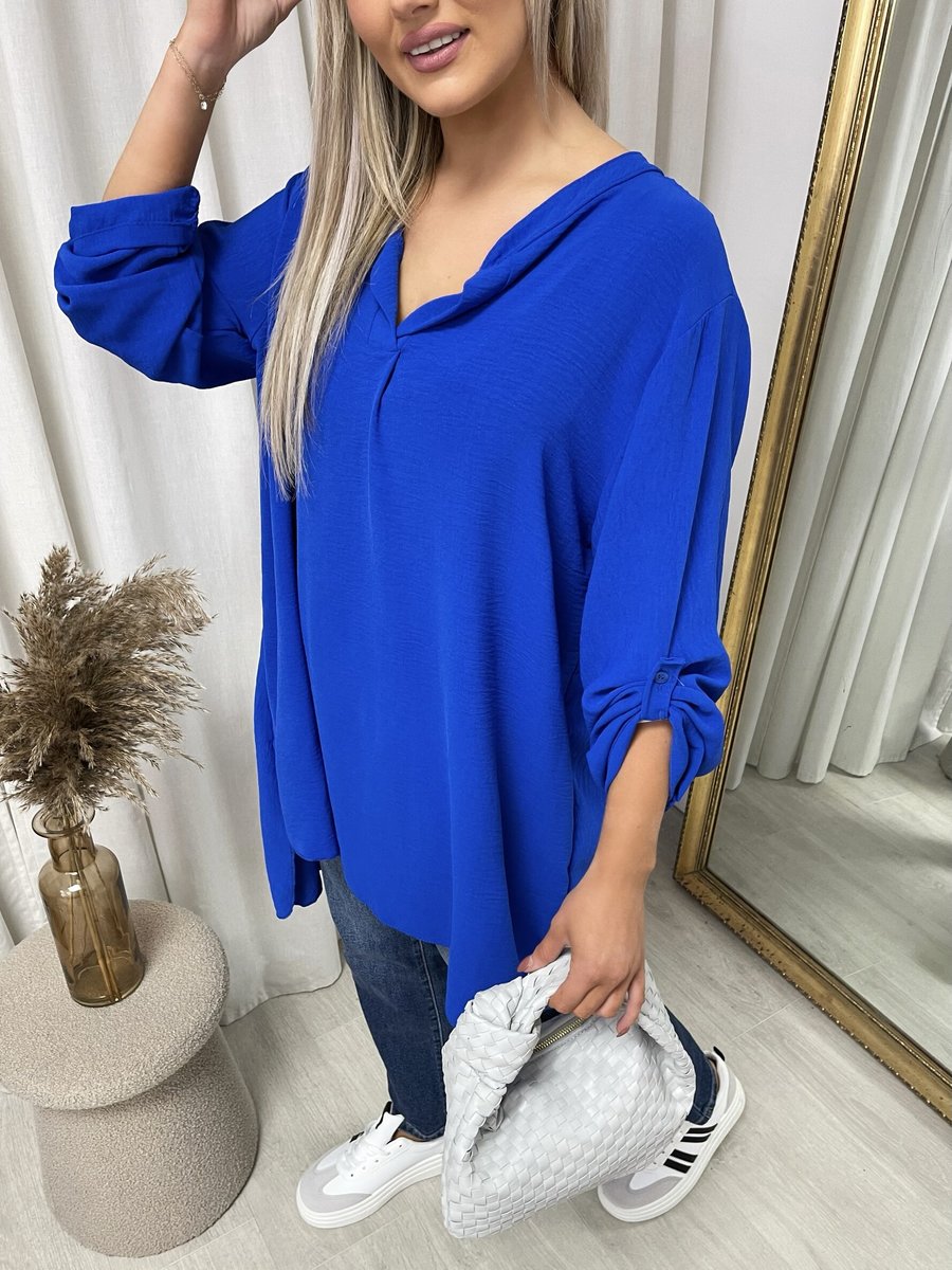 Loose-fit long-sleeve top in royal blue with V neckline and rolled cuffs