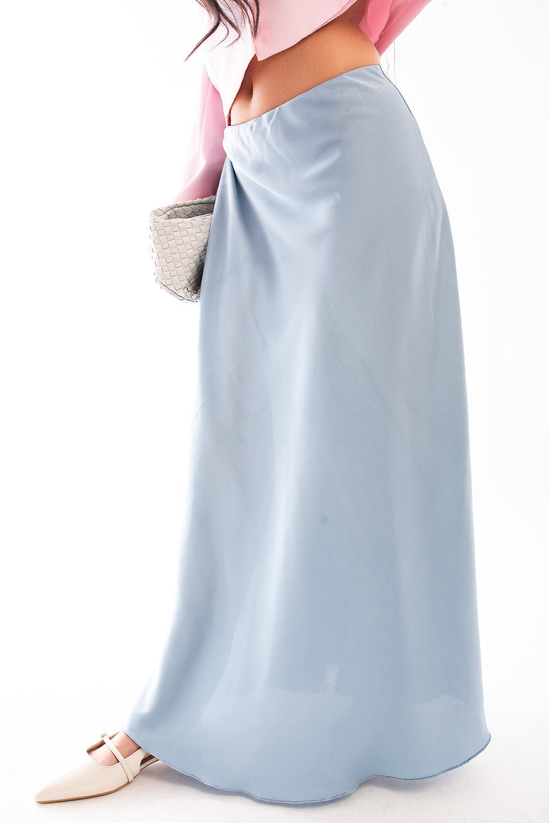 Light blue high-waisted maxi skirt with soft flow and full-length hem