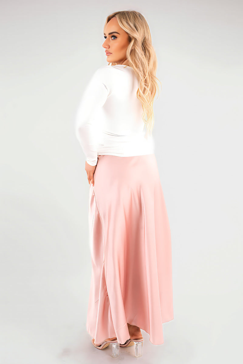 Pink high-waisted maxi skirt with draped, flowing fabric and wide waistband