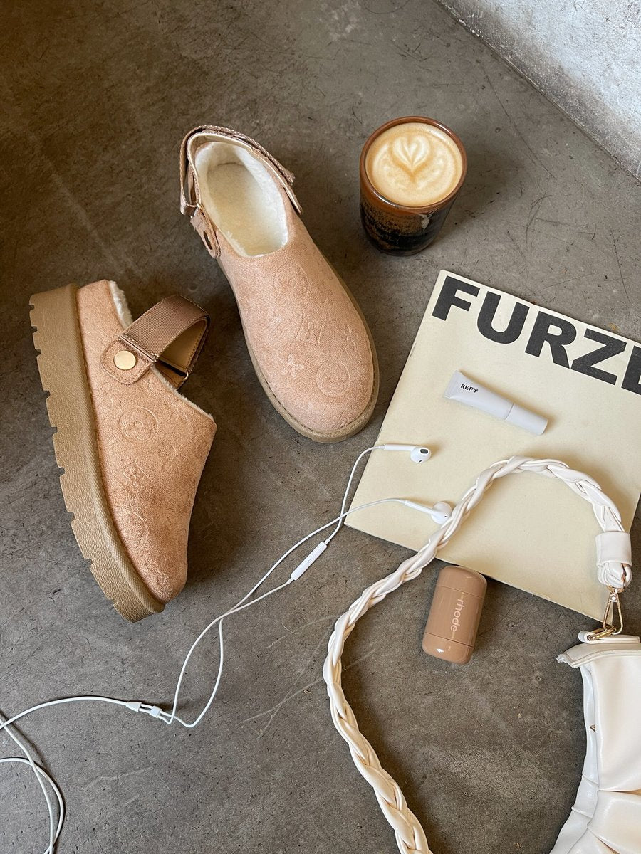 Beige printed sling-back platform clogs pair with ankle strap and rubber sole.