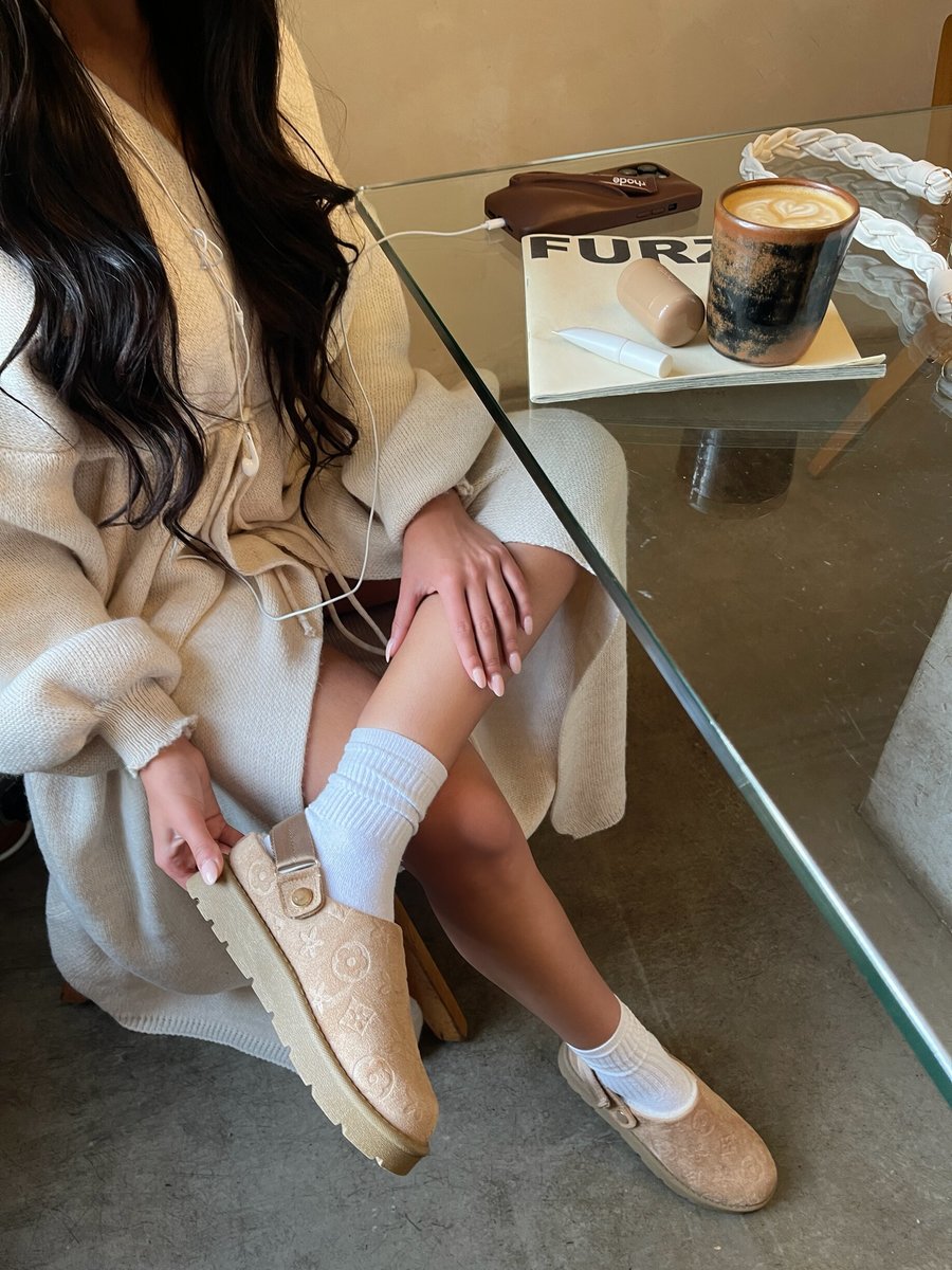 Beige printed sling-back platform clog with ankle strap, worn with light socks.