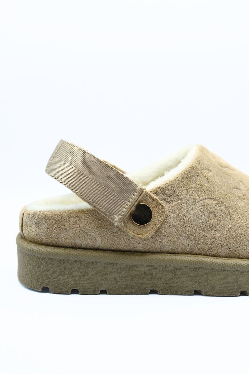 Beige faux suede sling-back clog with adjustable strap and textured upper detail.