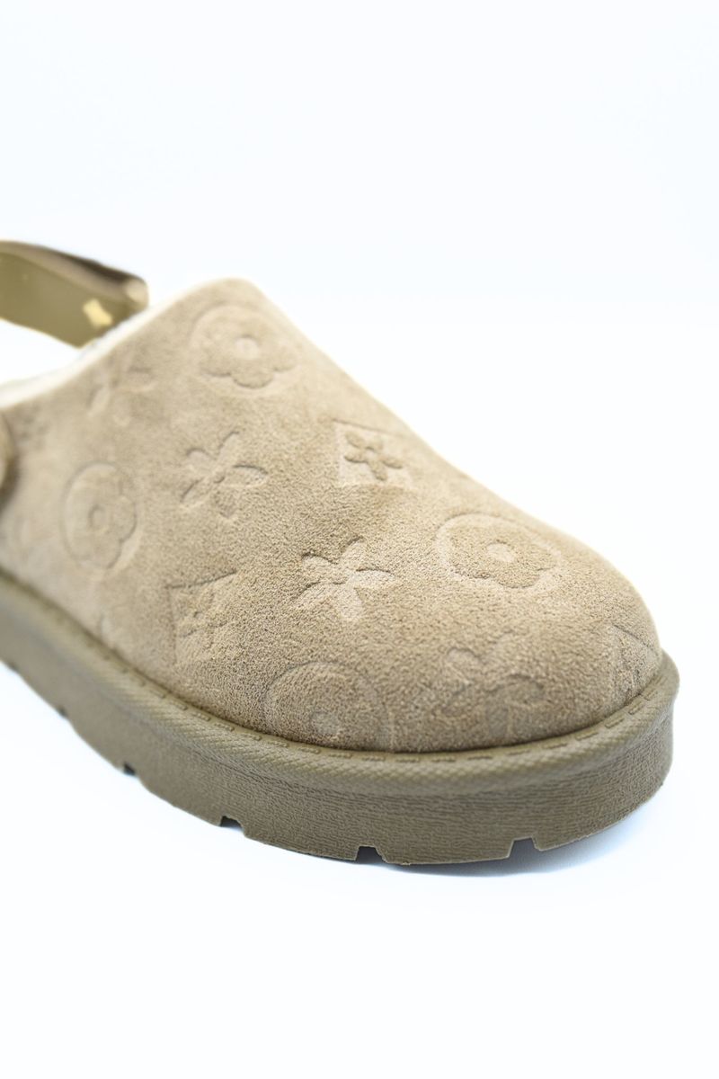 Beige printed slip-on clog with textured floral pattern and thick platform sole.