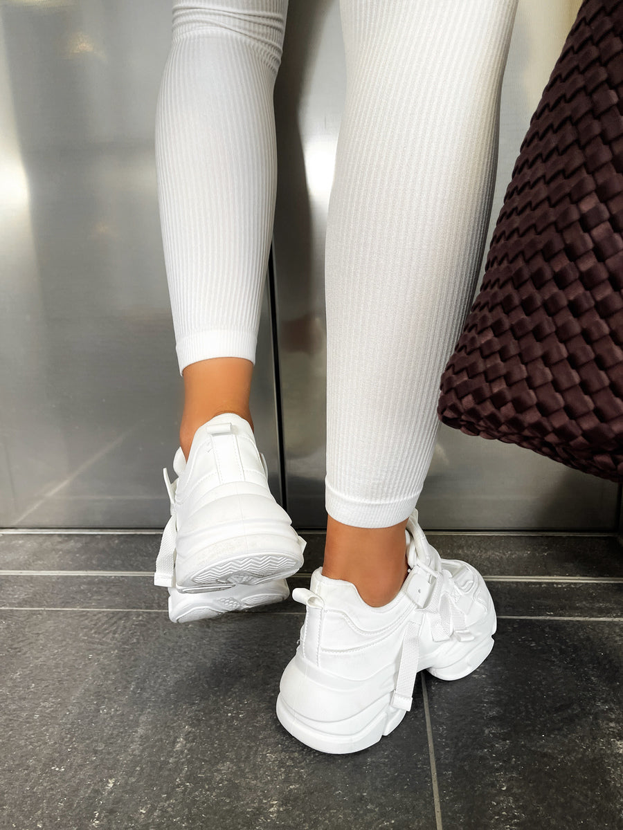 White lace-up platform chunky trainers, close-up of side and sole