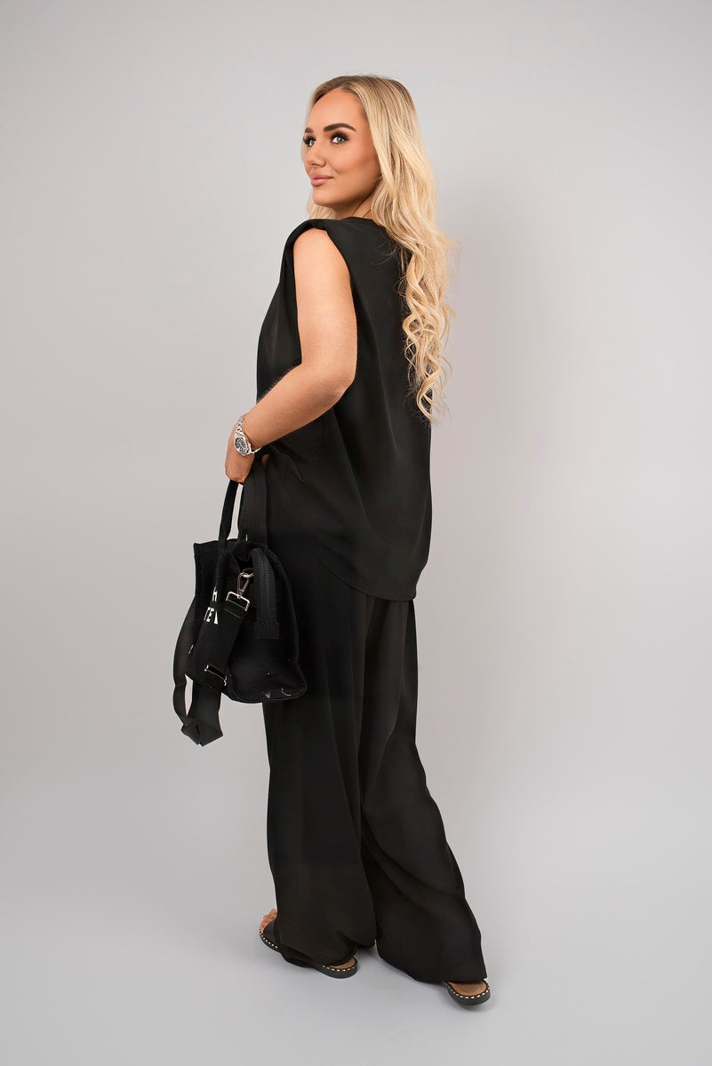 Black sleeveless top and wide-leg trousers co-ord set, back/side view