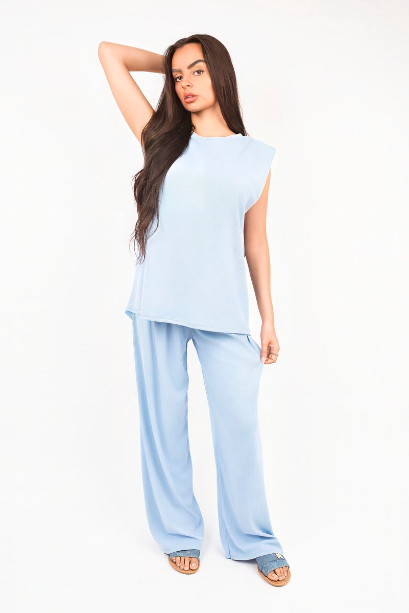 Light blue sleeveless relaxed top and wide-leg trousers set, standing pose