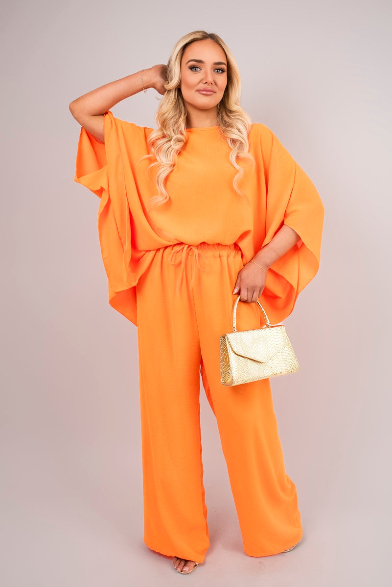 Orange batwing top and drawstring wide-leg trousers co-ord set with elastic waist.