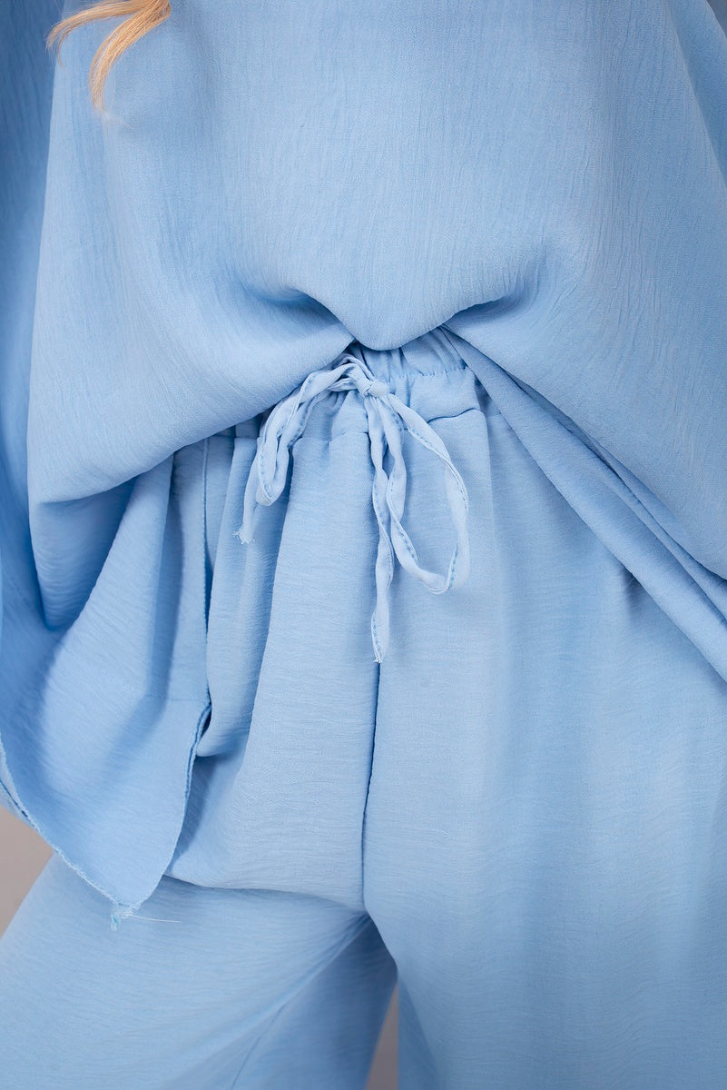 Light blue batwing top and drawstring trousers waistband with tie