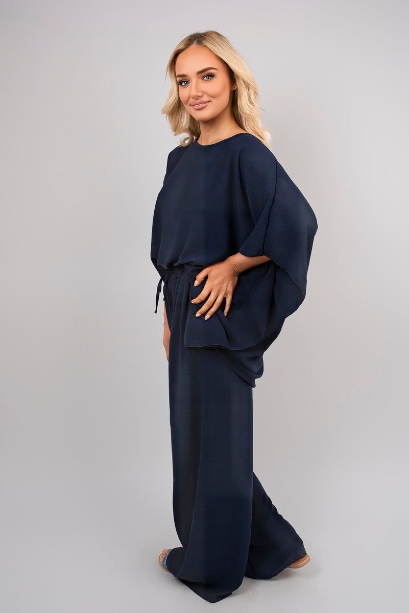 Navy batwing top and drawstring wide-leg trousers with loose cape sleeves