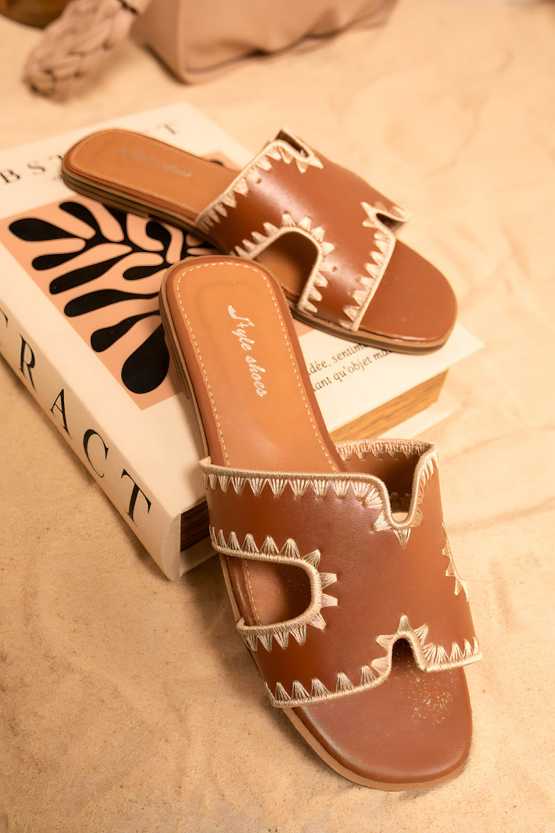 Tan-brown flat slip-on sandals with scalloped cut-out trim, open toe