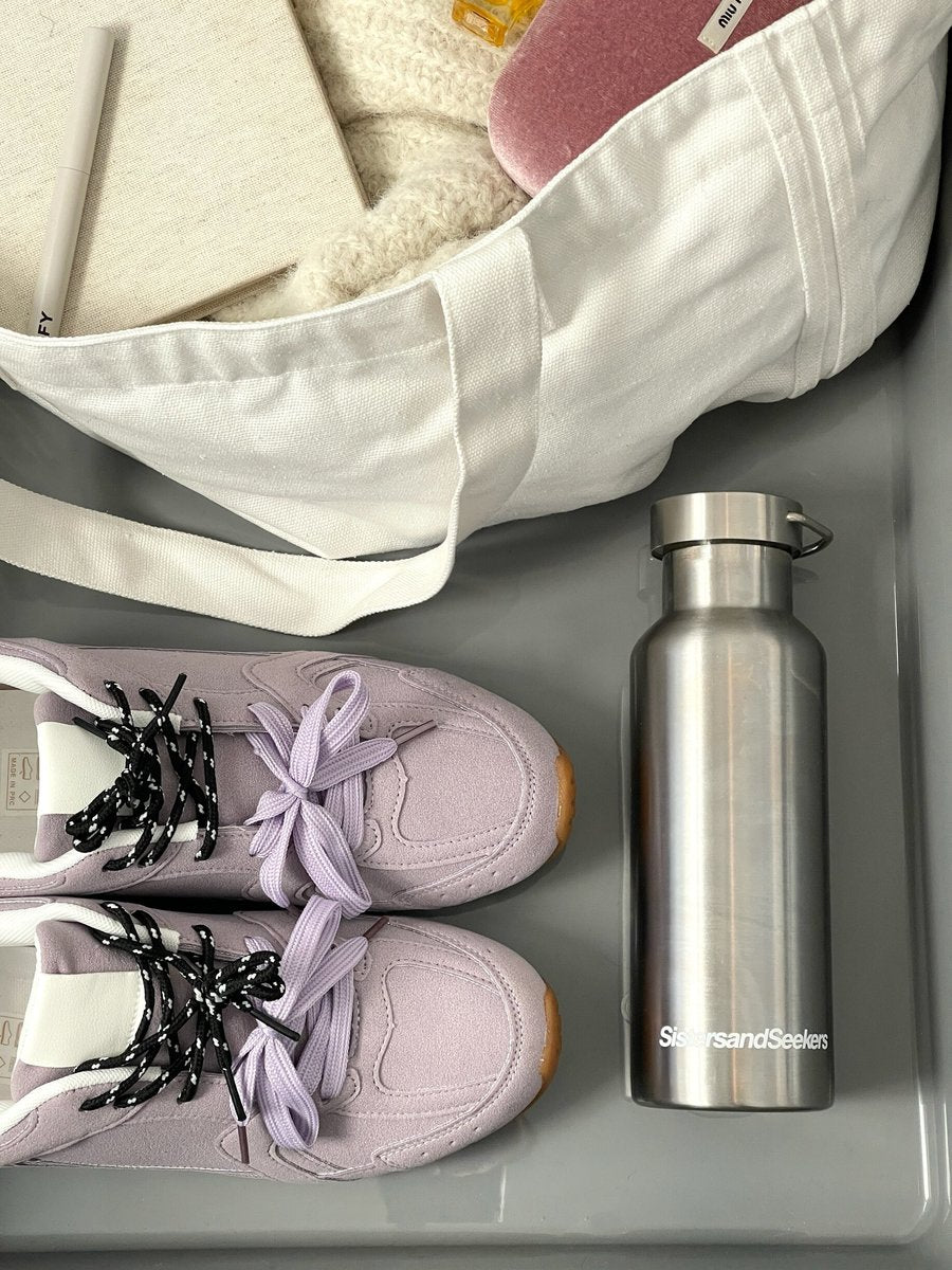 Lilac lace-up flat trainers with black laces and stitched side panels