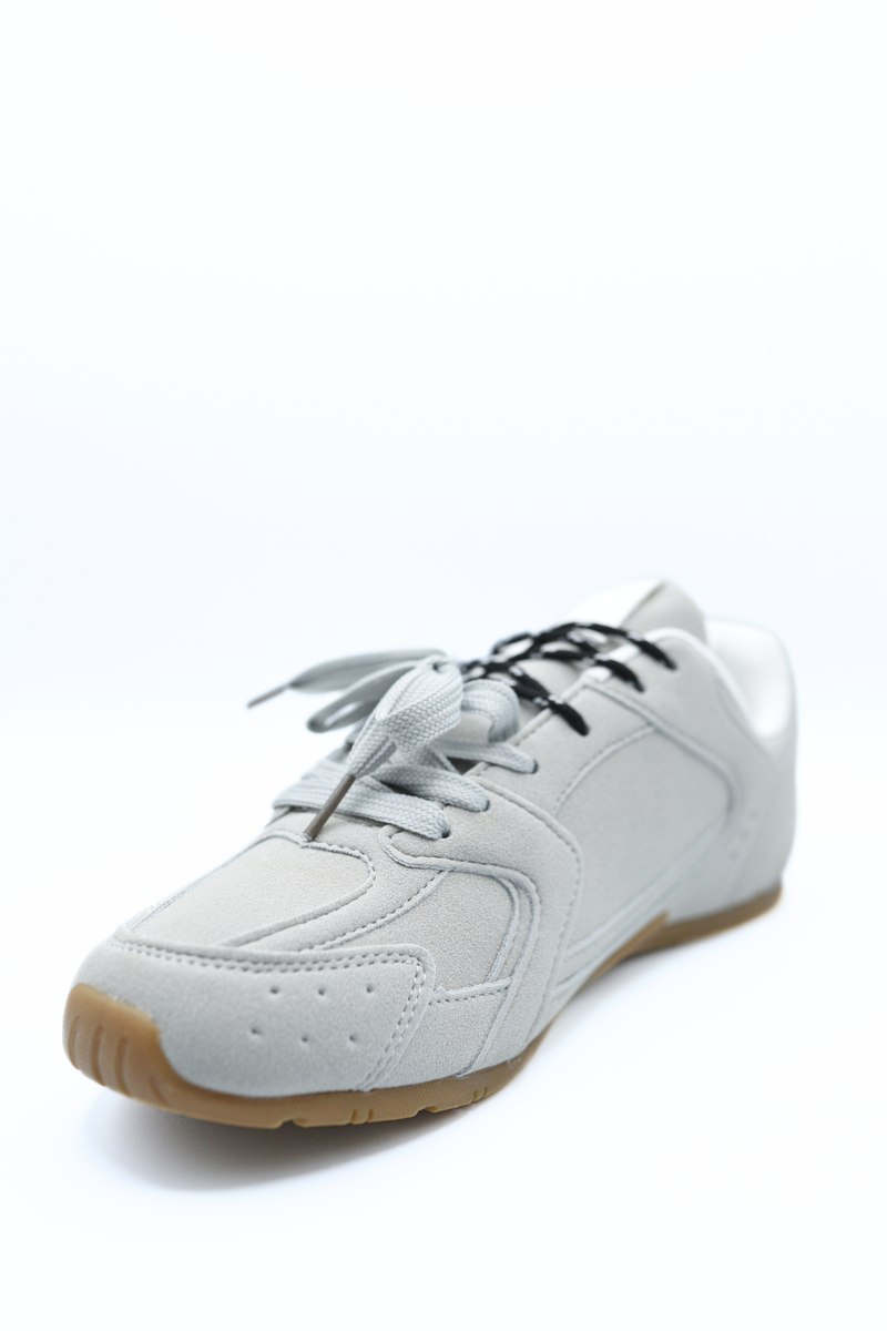 Light grey lace-up flat trainers with black laces, textured uppers and gum sole