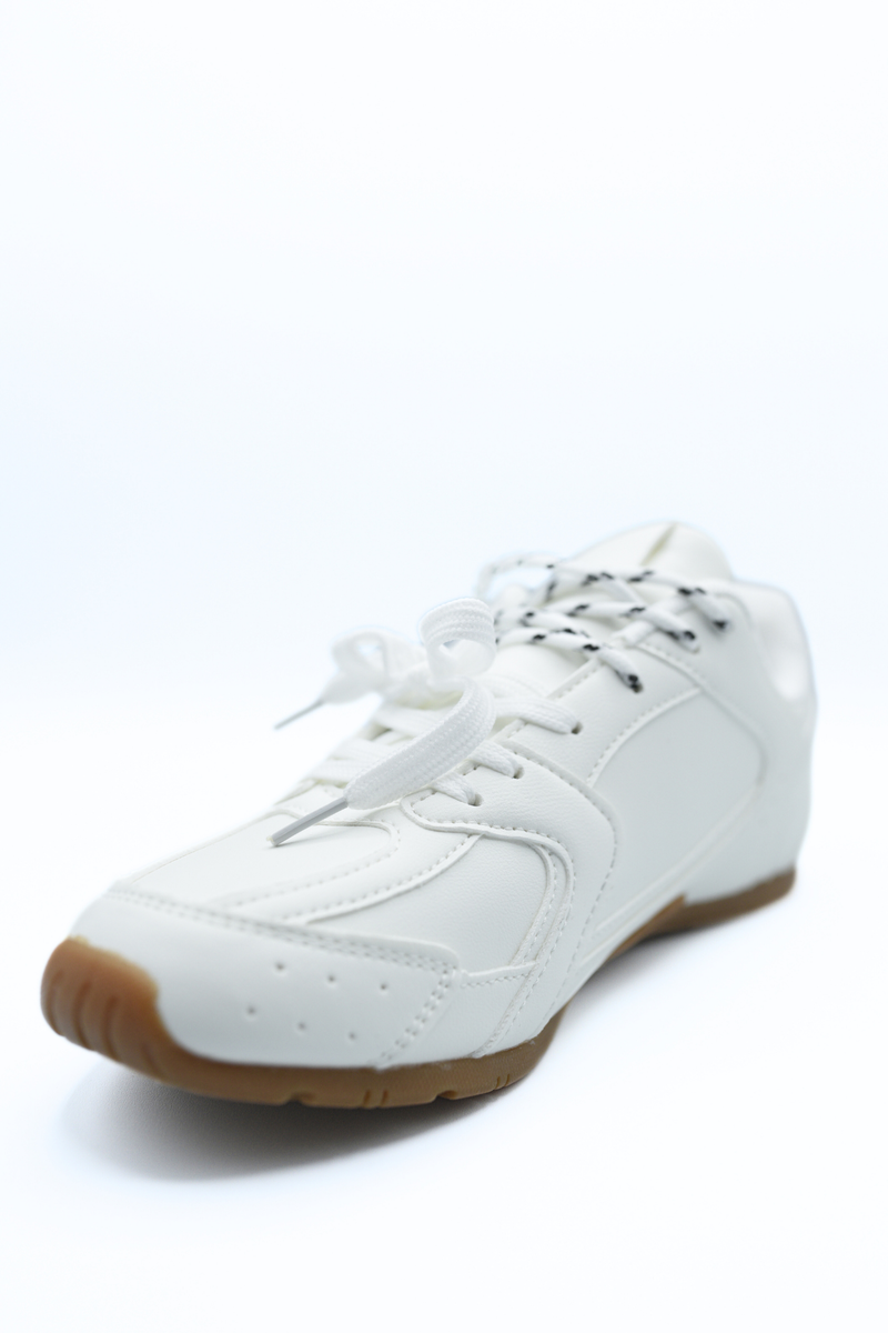 White lace-up flat trainers with stitched overlays and brown rubber outsole edge.